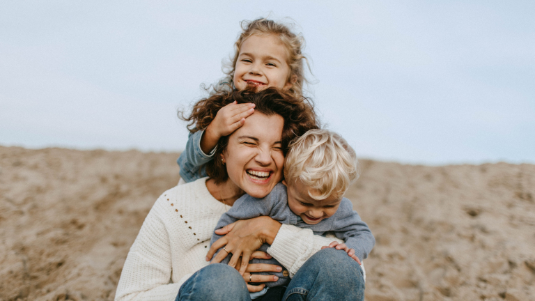 Una madre con i due figli che ridono